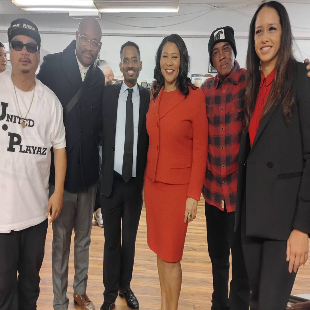 Oscar Grant Jr. with Oakland Mayor Barbara Lee and community partners at an event