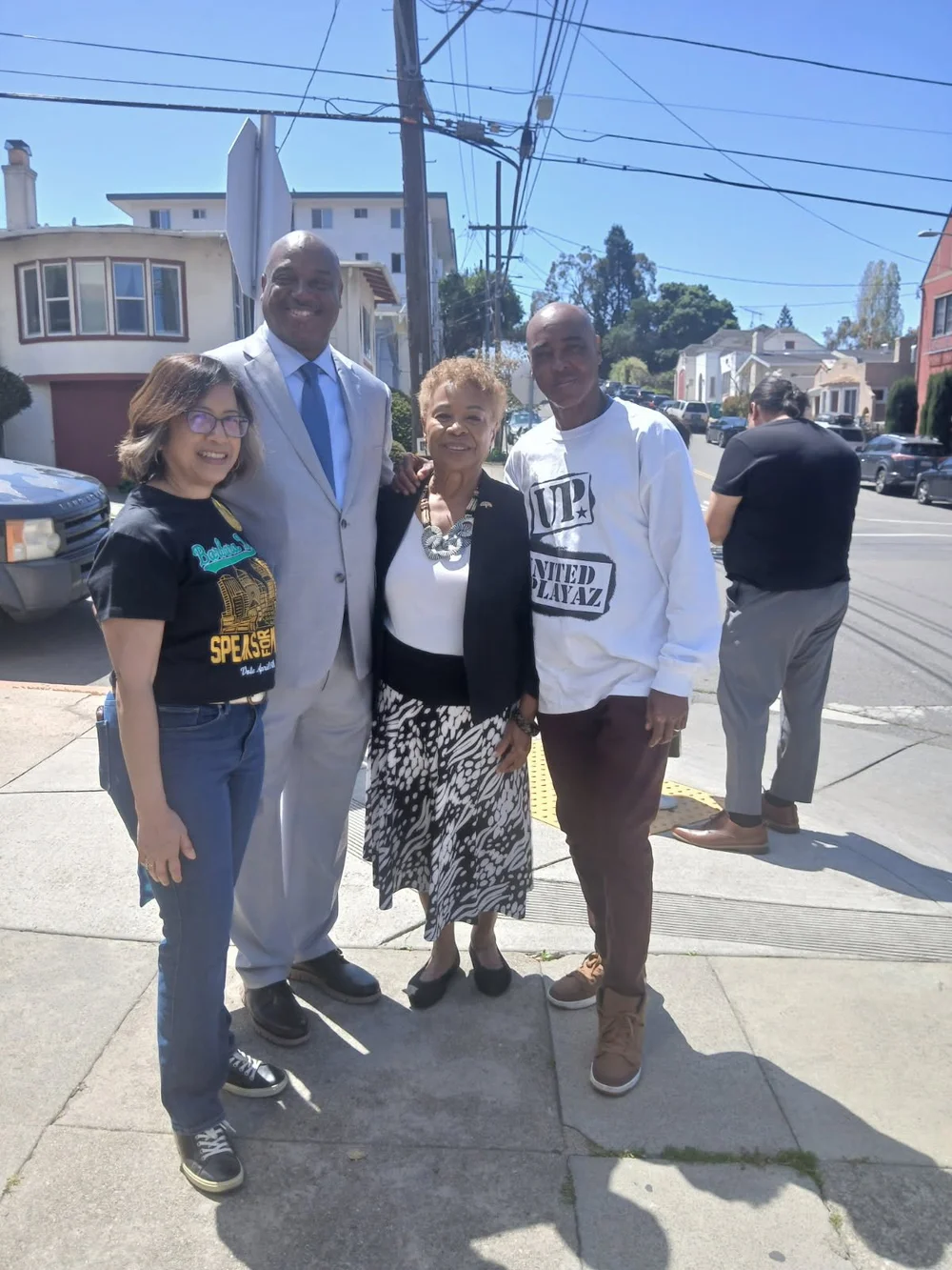 Oscar Grant Jr. and community leaders standing together outdoors in Oakland
