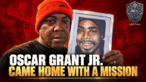 Oscar Grant Jr. holds a framed portrait of his son Oscar Grant III in an L&R Press article hero